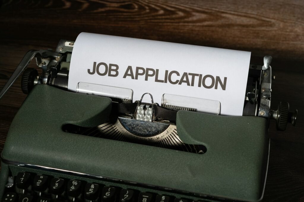 Typewriter with a job application – changing jobs before mortgage closing