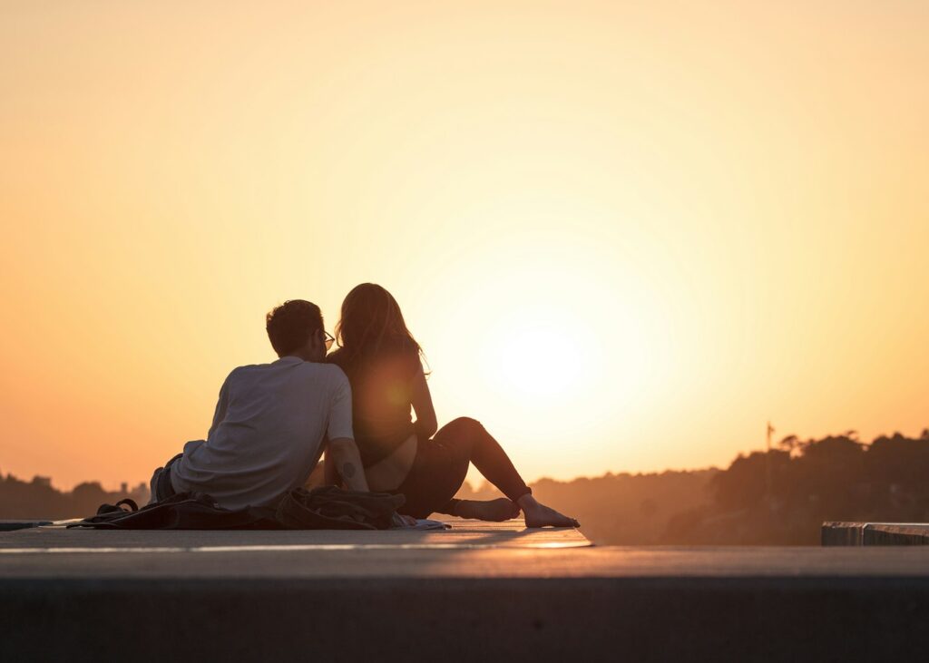 Couple sitting outdoors together – joint mortgage with bad credit