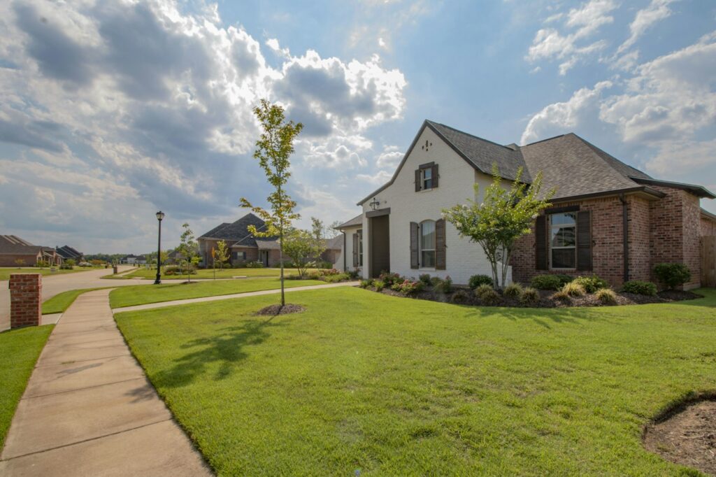 House with a green lawn – types of real estate agents